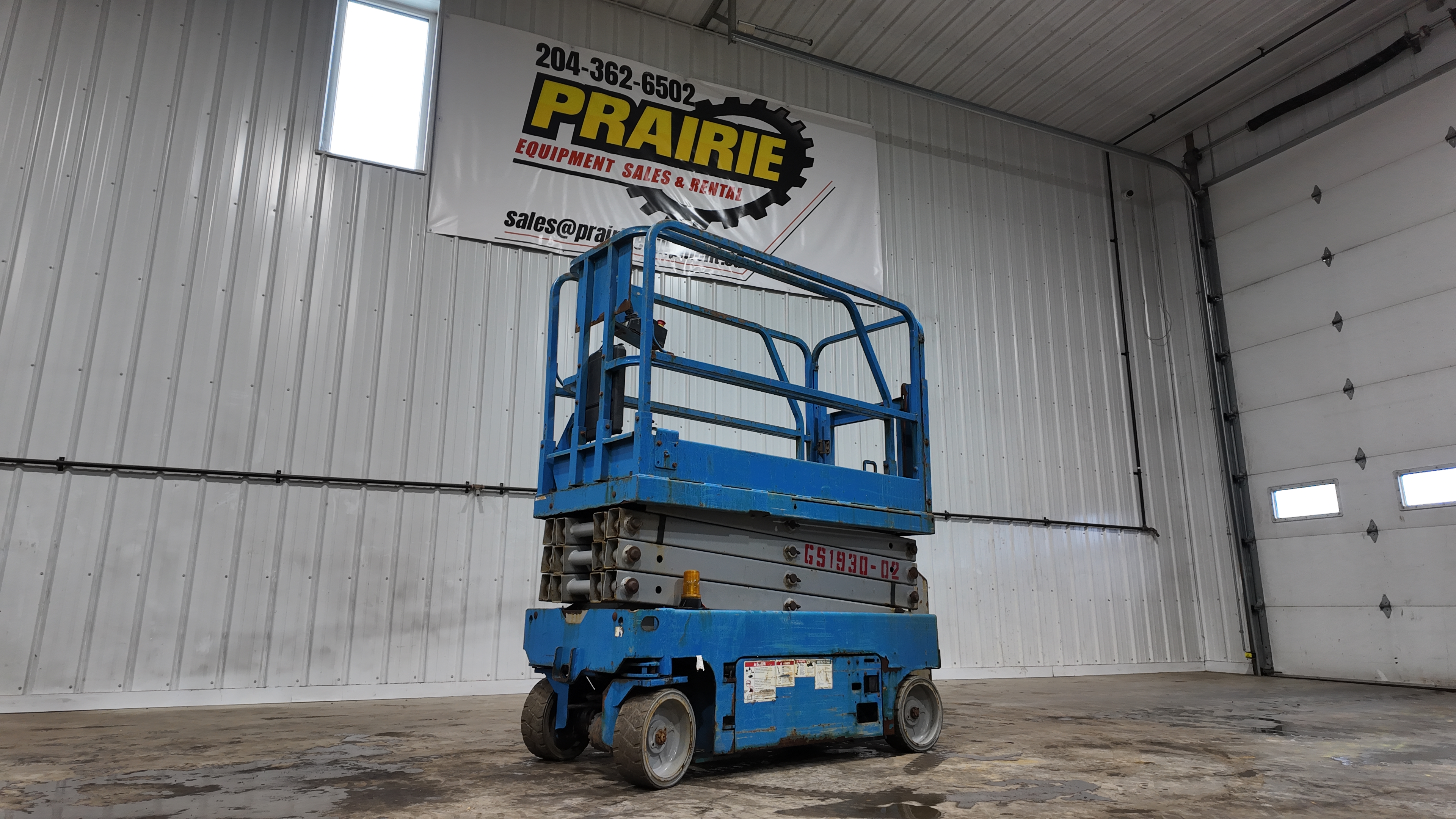 Genie GS-1930 class electric scissor lift — compact indoor units are common for warehouse, retail, and maintenance work.